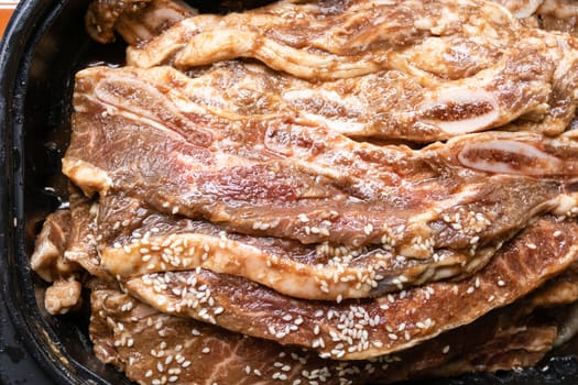 Bowl with stack of raw beef rib steaks