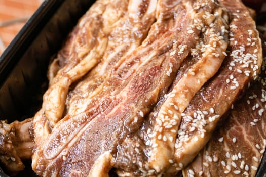 Bowl with stack of raw beef rib steaks