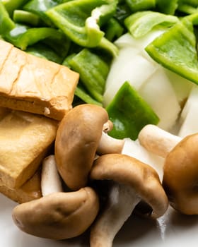 Green peppers, tofu, onion, and mushrooms in plate