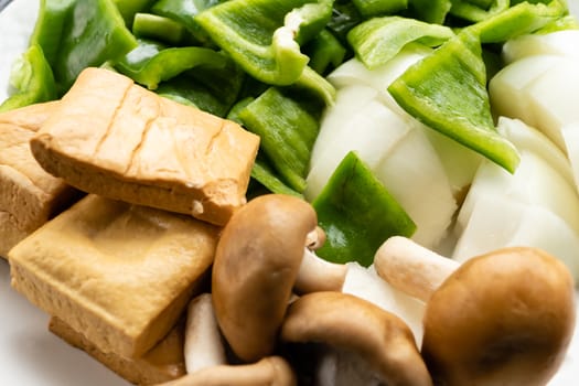 Green peppers, tofu, onion, and mushrooms in plate