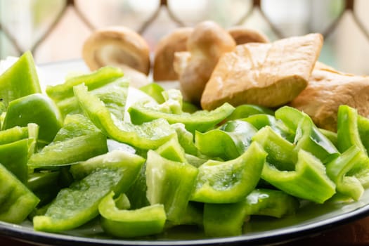 Green peppers, tofu, onion, and mushrooms in plate