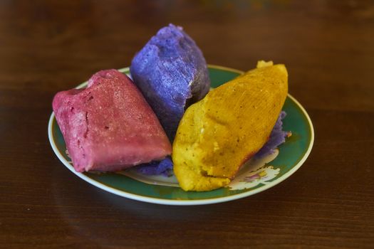 Corn tamales in colors, traditional Mexican food, sweet and chili flavors