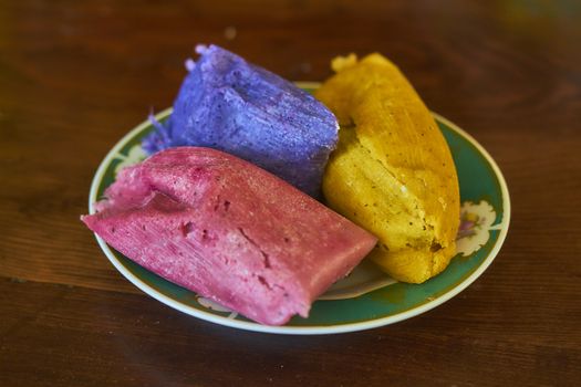 Corn tamales in colors, traditional Mexican food, sweet and chili flavors