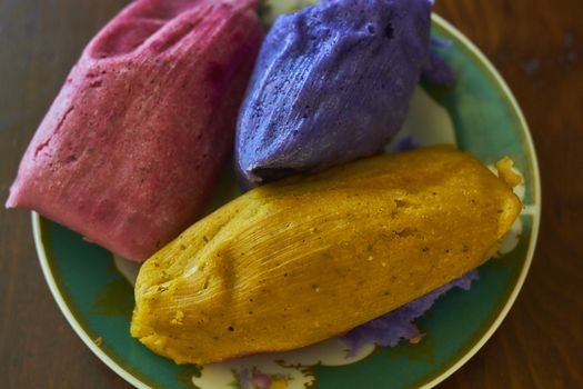 Corn tamales in colors, traditional Mexican food, sweet and chili flavors