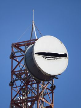 A closeup view of the top part of a tall mobile communication tower.                               