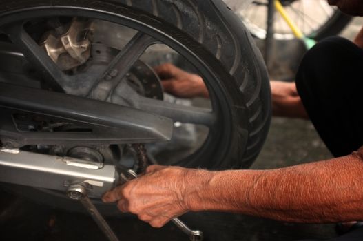 Close up,People are repairing a motorcycle .