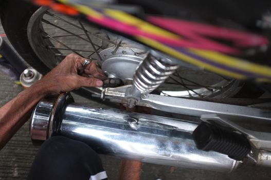 Close up,People are repairing a motorcycle .