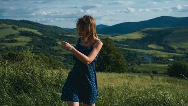 Woman in mountains at sunny day time. Beautiful natural mountain background. Ukraine, Carpathian mountains. Natural colors