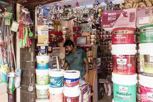 Kolkata, West Bengal, India 1st January, 2019 - A paint seller shop owner working inside his hardware store.