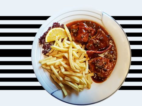 Various grilled meats with french fries on white dish