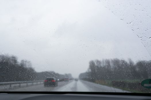 Traffic jam on rainy bad day, raindrops on car window