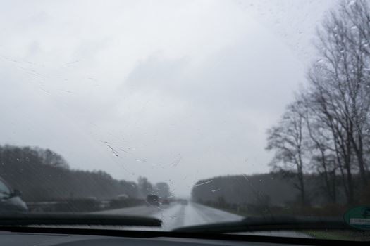 Traffic jam on rainy bad day, raindrops on car window