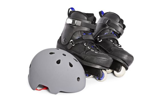 Close up of black aggressive inline skates and a helmet, isolated on white background.