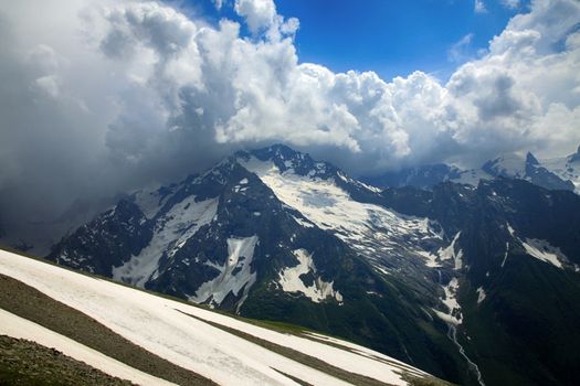 Panorama of mountains scene with dramatic blue sky in national park of Dombay