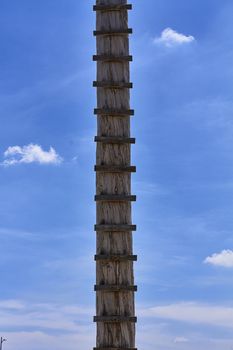 rustic wooden staircase, blue sky and clouds