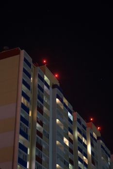 Apartment building on the background of the night sky. Close-up.