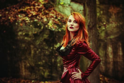 cute red head girl with fetish jacket outdoor pose