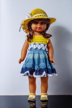 Old vintage doll in a beautiful outfit, in dress, shoes and hat