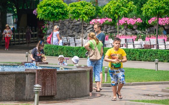 Odessa, Ukraine - 06.09.2019. People spend their families relaxing by the fountain in Gorky Park in Odessa, Ukraine, on a sunny summer day