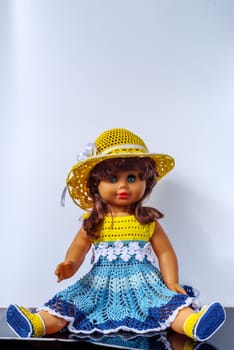Old vintage doll in a beautiful outfit, in dress, shoes and hat