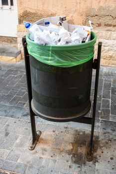waste bin full to overflowing in Spanish street