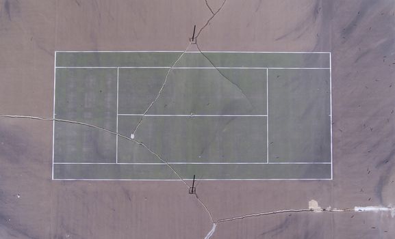 Old tennis court with cracks in it