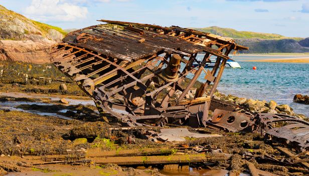 Murmansk region, Russia / August 2019. Cemetery of ships in the Murmansk region. Landmark. Destroyed wooden ships on the shore. Rough water-and wind-damaged wood of old ships.