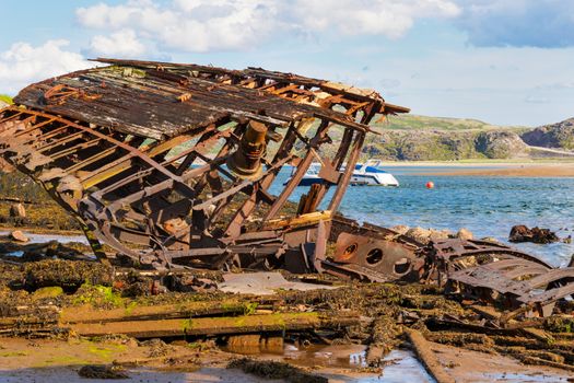 Murmansk region, Russia / August 2019. Cemetery of ships in the Murmansk region. Landmark. Destroyed wooden ships on the shore. Rough water-and wind-damaged wood of old ships.