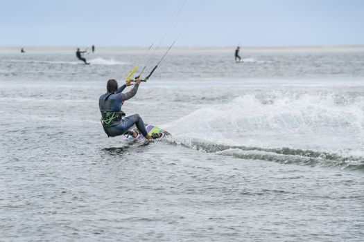 a man doing kitesurf at the sea