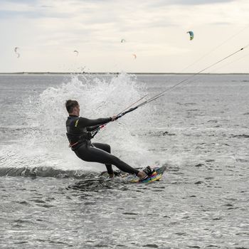 a man doing kitesurf at the sea