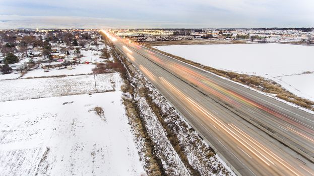 Traffic moving fast and showing motion blur during winter time