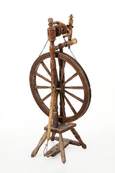 Old spinning wheel on an isolated studio background