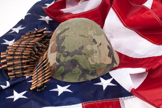 Band with cartdidges and army helmet on an american flag
