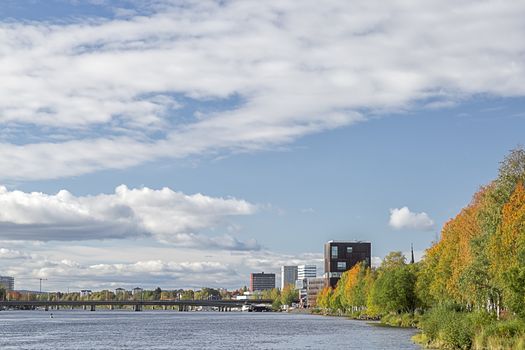 Downtown Umeå, Sweden in Fall with a partly cloudy sky.