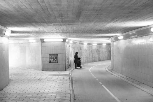 Female with Baby Stroller in Tunnel.