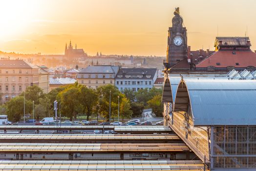 Prague Main Train Station, Hlavni nadrazi, with historical buildings and Prague Castle on the background at sunset time. Prague, Czech Republic.