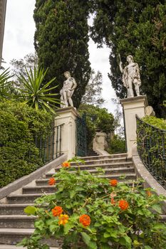 Achilleion palace, Corfu, Greece - August 24, 2018: Classical statues at the Achillion Palace on the island of Corfu.