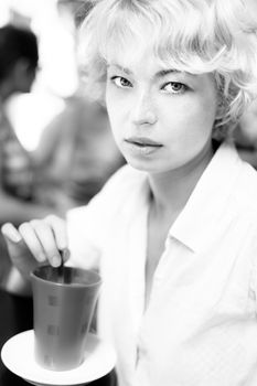 Casual Dressed Beauty Girl With Cup of Coffee in black and white. Vintage black and white photo.