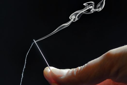 Abstract sewing needle and smoke 