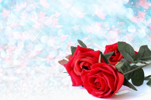 Red roses bouquet with blue bokeh and free space for text, valentine twinkled bright background.