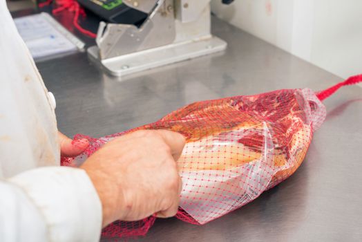 Manufacturing Vacuum packed ham. Meat industry.