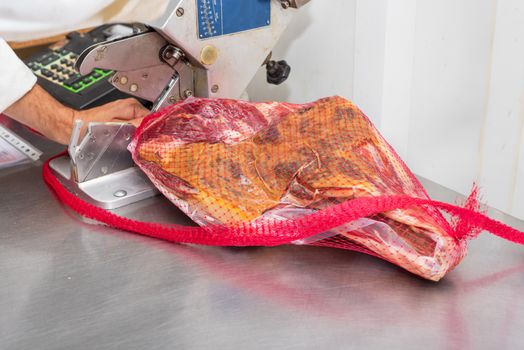 Manufacturing Vacuum packed ham. Meat industry.