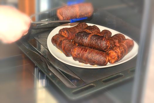 Fresh beef roulades braised in a dish in the oven.