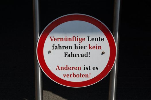 Traffic signs with inscription in German - Reasonable people do not ride a bicycle here, other people it is forbidden