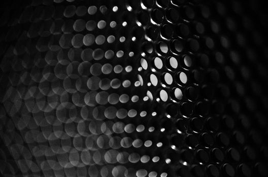 Macro photography of the holes from a speaker's mesh, background