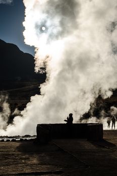 Shocked woman gazes at the sun thrugh a steam veil in Atacama desert, Chile