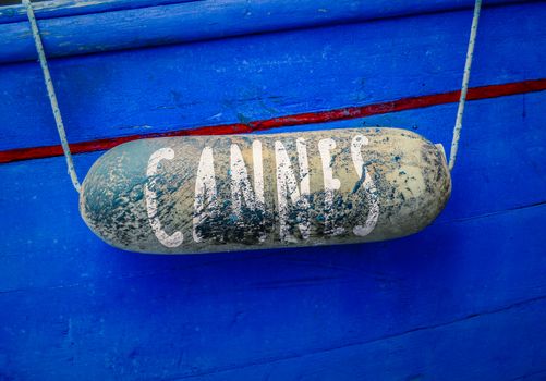 A Sign For Cannes, Famous For The Film Festival, Written On A Buoy Of A Rustic Boat