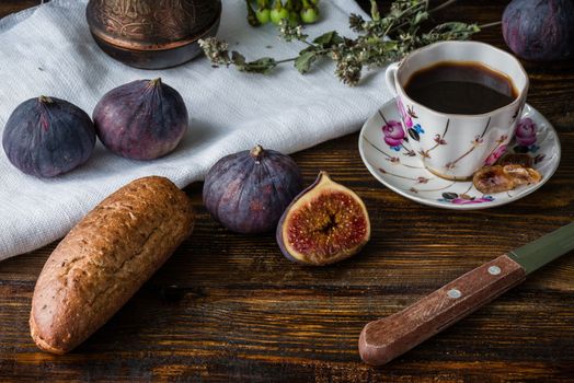 Breakfast with coffee, bread and few juicy figs.