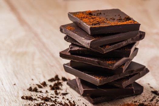 Stack of Dark Chocolate Bars with Cayenne Powder