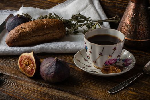 Light breakfast with coffee, multicereal bread and few ripe figs.